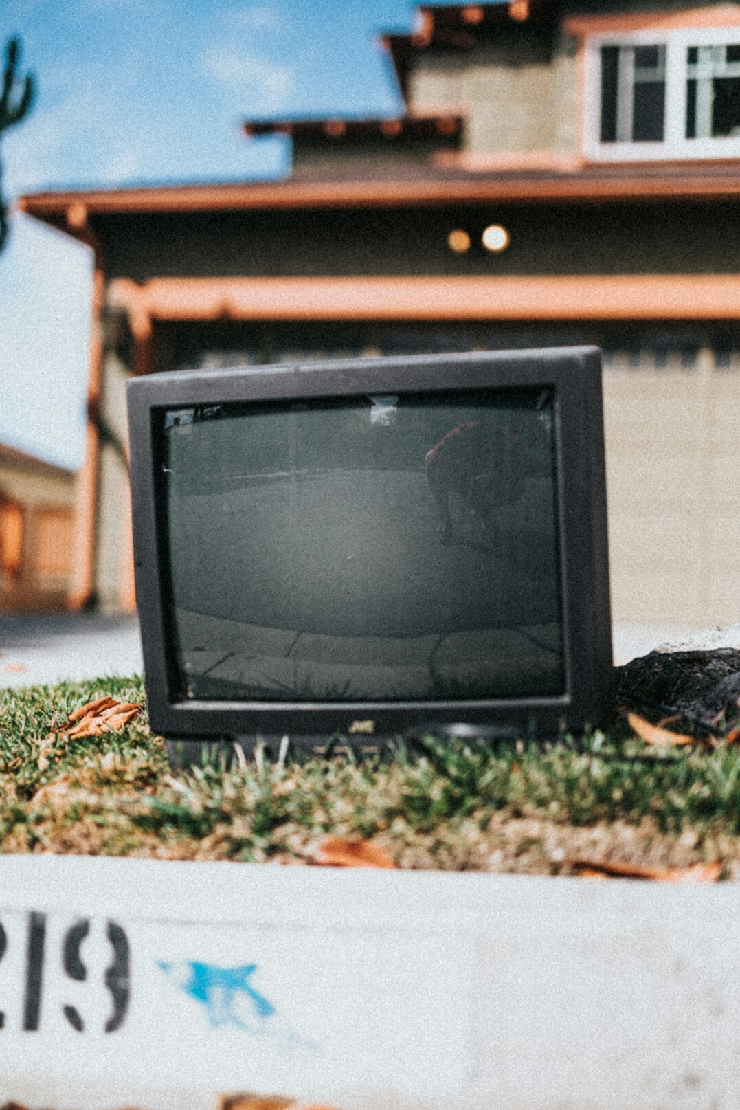 Vintage CRT television broadcasting a commercial in a dim studio