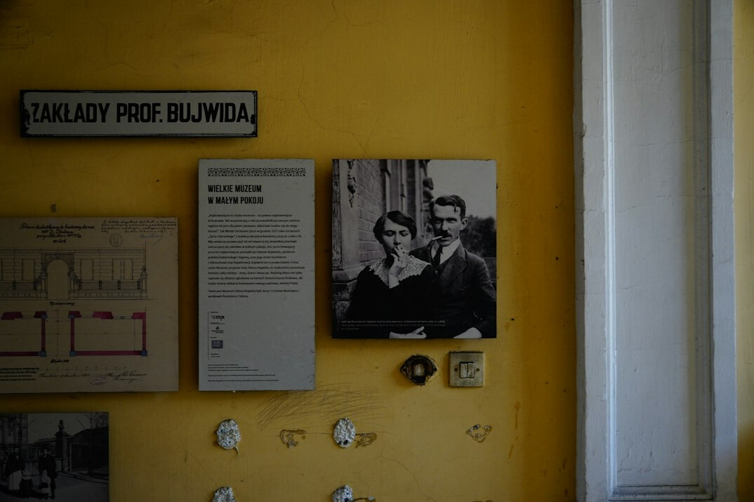 Two colleagues examining vintage advertising posters in an archive room